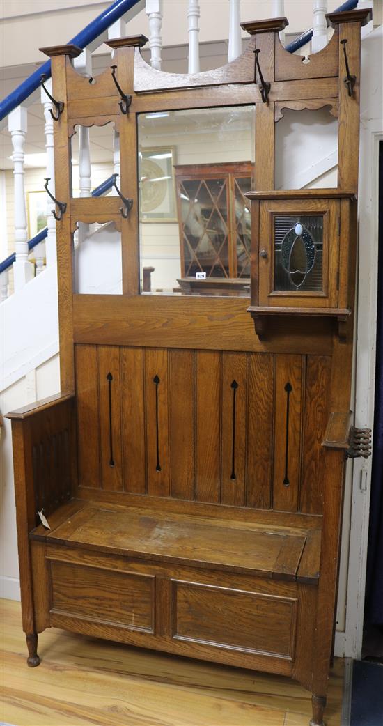 An early 20th century Arts & Crafts oak hall stand W.110cm